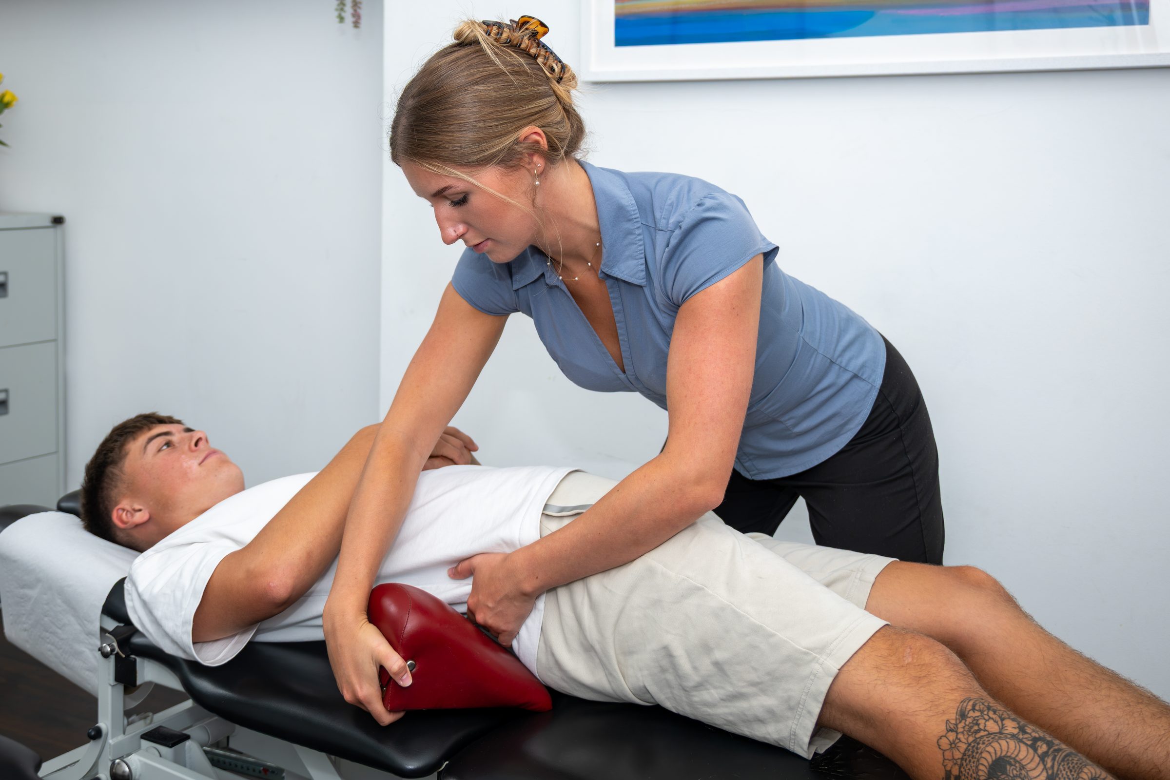 Anya treating a patient on the drop-piece couch